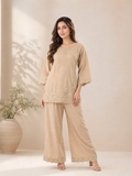 Beige embroidered kurta pant set for women with floral detailing, styled on model with minimal neutral background