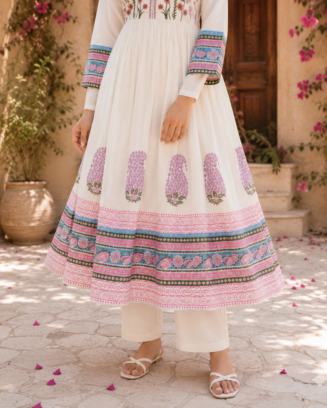 Close-up of white cotton straight pants paired with ethnic suit set